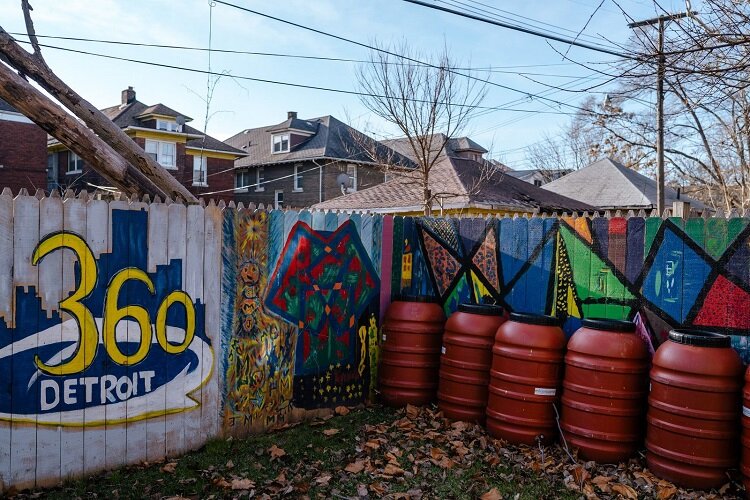 A colorful fence surrounds 360 Detroit's Art House.