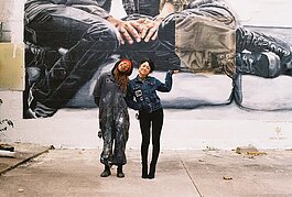 Bakpak Durden and Cyrah Dardas stand in front Durden's mural titled “a constellation in winter” located at the LGBT Center in Detroit.