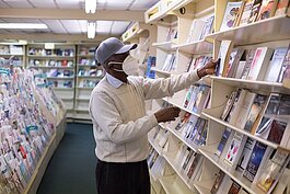 Walter Baker stocks the shelves at his Detroit shop, Baker's Bible and Bookstore.