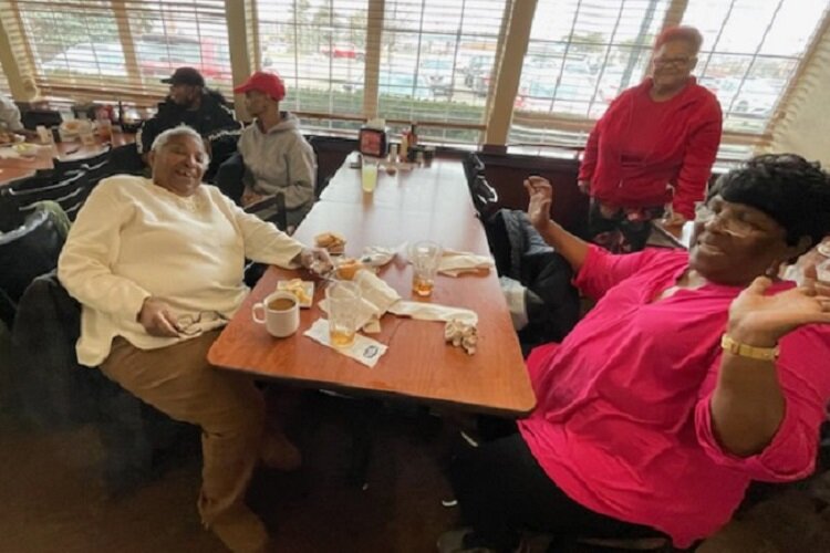 Participants with the Raising Hope Senior Program enjoy a trip to the Golden Corral restaurant.