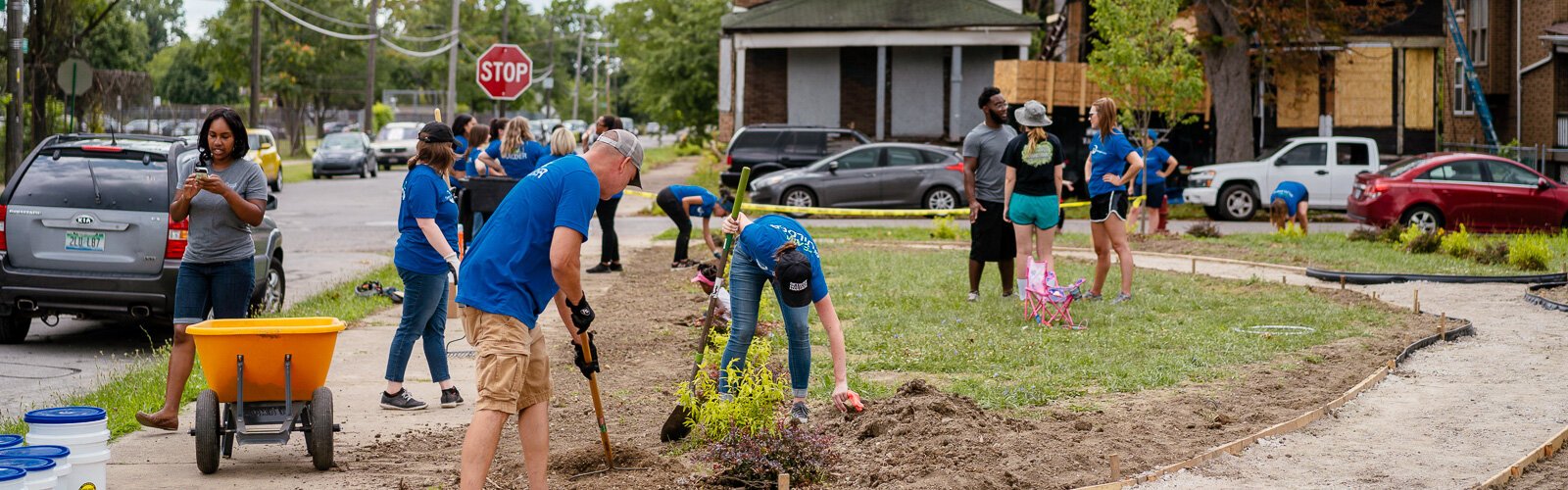 Volunteers from the Detroit Regional Chamber tend to the new art park in NW Goldberg.