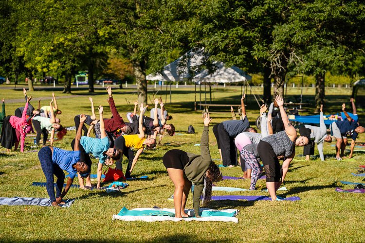 Participants practice yoga at Detroit's Palmer Park.
