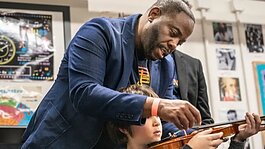 Damien Crutcher, managing director of Detroit Harmony, at an instrument distribution at Detroit Prep