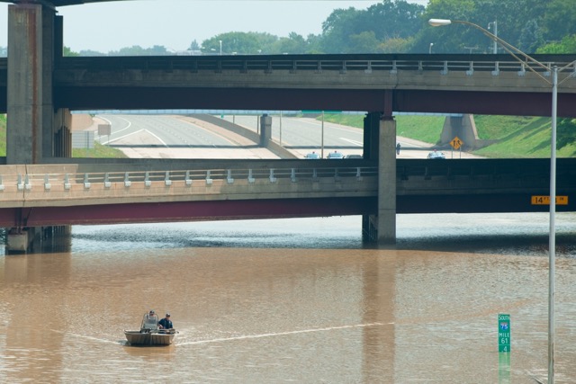 Police pilot a boat in a flooded portion of I-75 on August 12, 2014. A pumping station failed during heavy rains the night before leading to flooding.