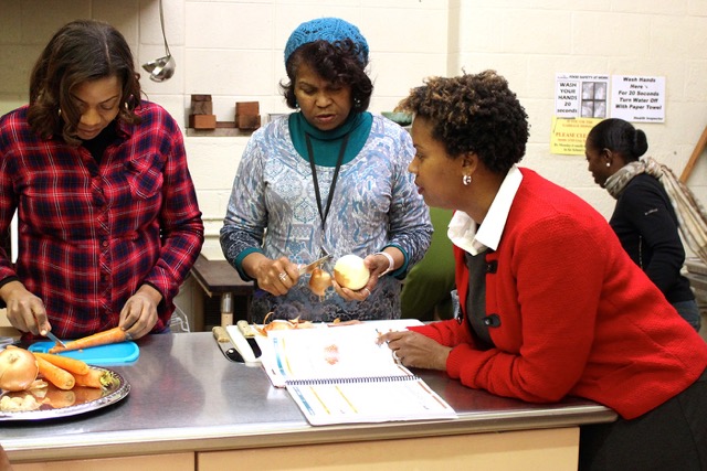 Instructor and nutritionist Winona Bynum (right) calls the shots from the ATOAH recipe book