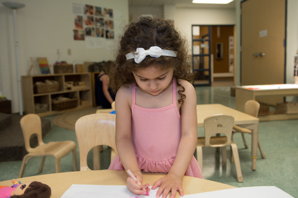 Nala Saab draws at the UM Dearborn Early Childhood Education Center