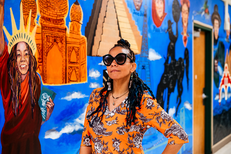 jessica care moore in front of the "Unity Mural"