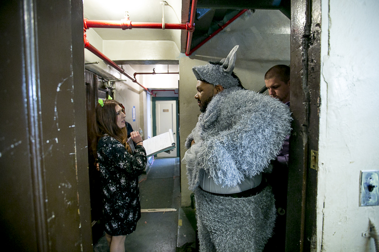 Jonathan Jones puts on his Donkey costume before a before a performance of Shrek: The Musical