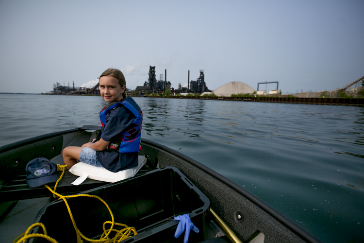 Jessica Speiss rides in her dad’s boat in during a Trash Fishing outing near Zug Island