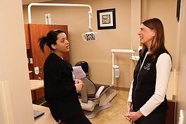 Kimberly Singh (right), Michigan Oral Health Coalition board member and chief community and governmental affairs officer for My Community Dental Centers, chats with Dental Assistant Kortney Jones.