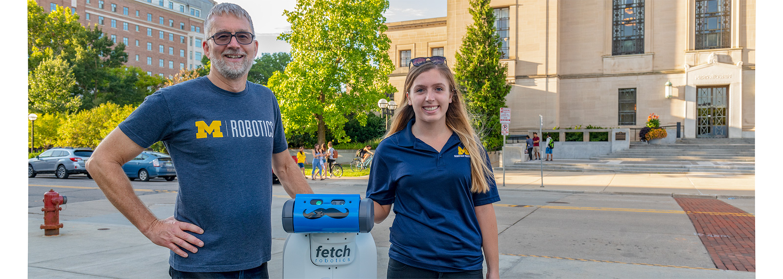 Jessy Grizzle and Liz Olson of U-M robotics with the robot "Fetch"