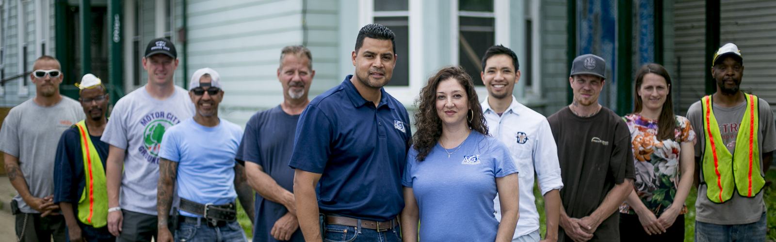 Luis Ali and Tanya Saldivar-Ali with the crew of AGI Construction, a southwest Detroit-based construction company