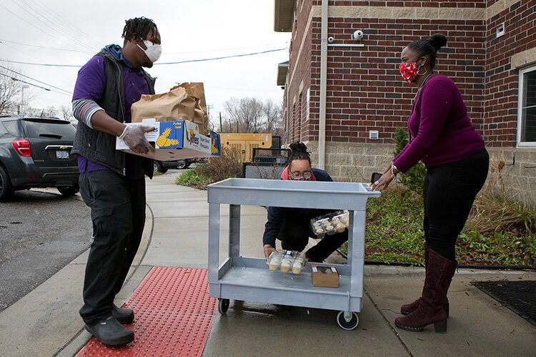 Godwin Ihentuge and Garnet Gullett delivers meals and dessert to Alternatives For Girls.