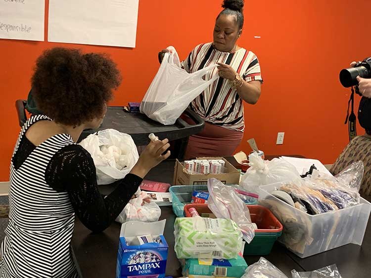 Alternatives for Girls employees pack kits for AFG's Crisis Resource Center for distribution on the streets and for walk-ins.