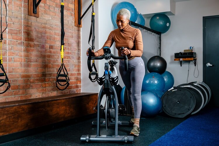Amina Daniels of LCD stands near one of her studios exercise bikes.