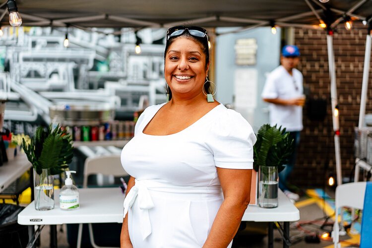 Anita Zavala of DHDC poses in front of the Fantazma Cafe.