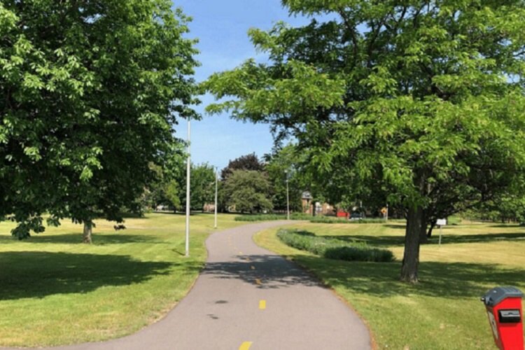 A section of the Dennis Archer Greenway surrounded by trees.