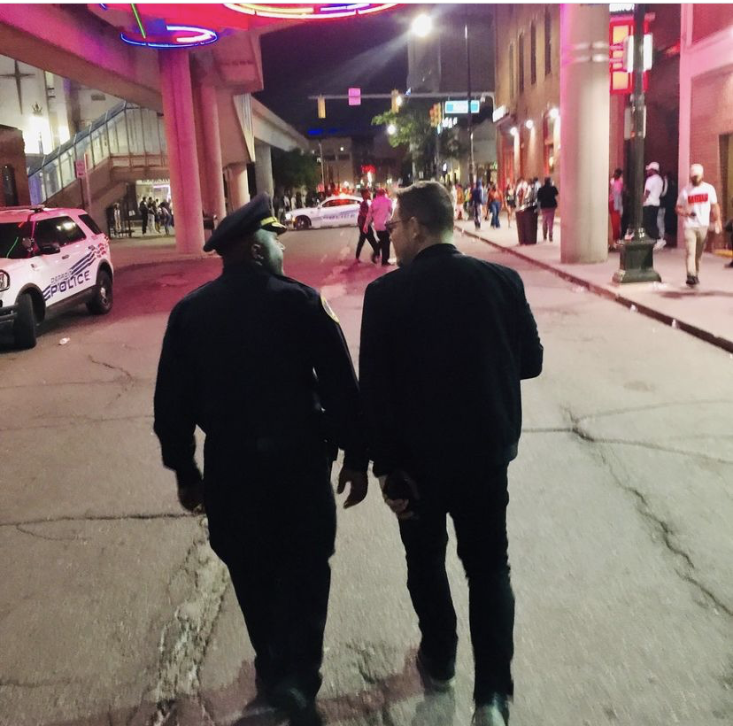 Commander Franklin Hayes walks with Adrian Tonon through downtown Detroit
