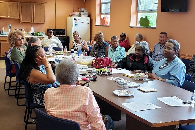 Elders break bread at a Bridging Communities event.