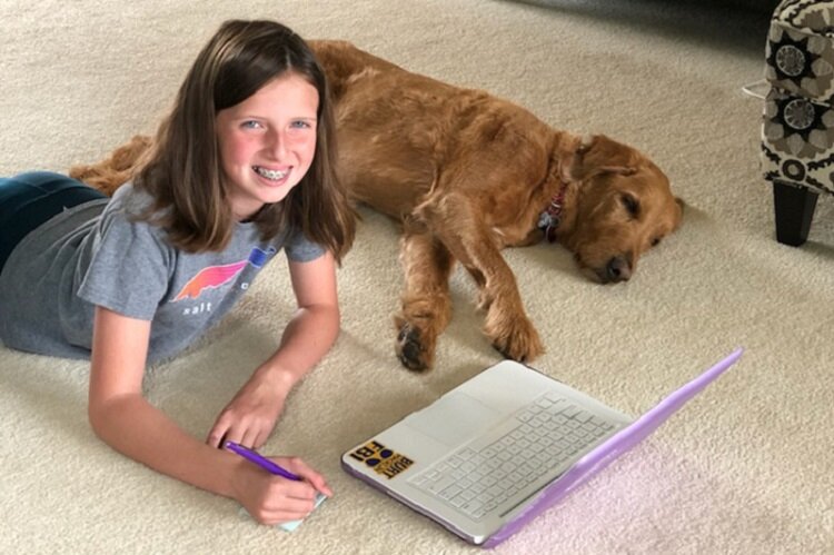 Brooke Simon studies with her family dog.