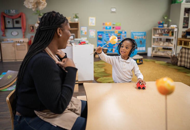 Makayla McKenzie works one-on-one with a student