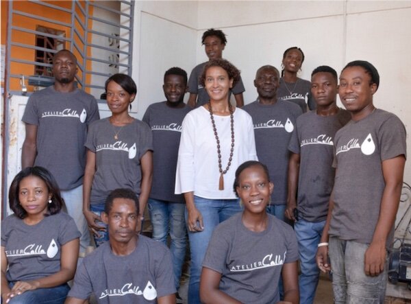 Christelle Chigand Paul flanked by Haitian artisans and creators.