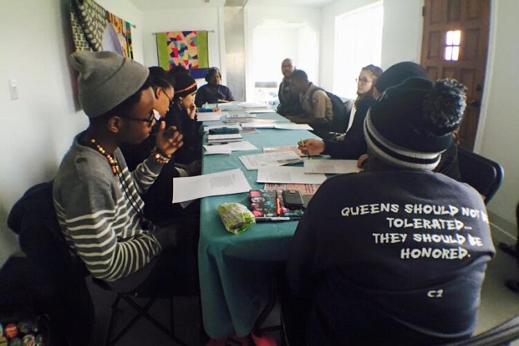 A group of Citywide Poets talk about their writing during a workshop.