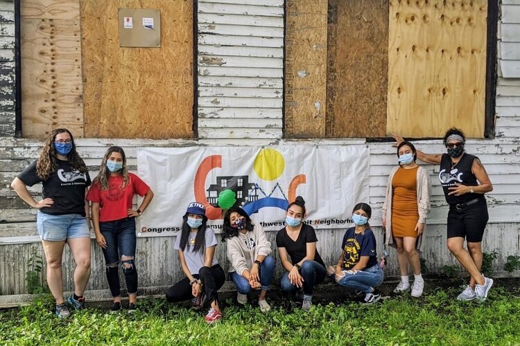 COC Youth stand in front of their future youth center.