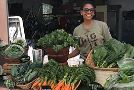 Dazmonique Carr works at Earthworks' Farmers Market in 2018 when she was an E.A.T. participant.