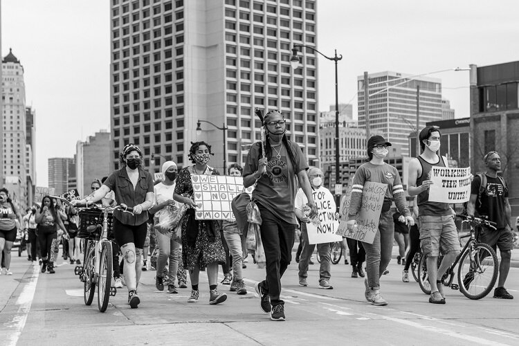 DED members and supporters march to raise awareness about their cause.