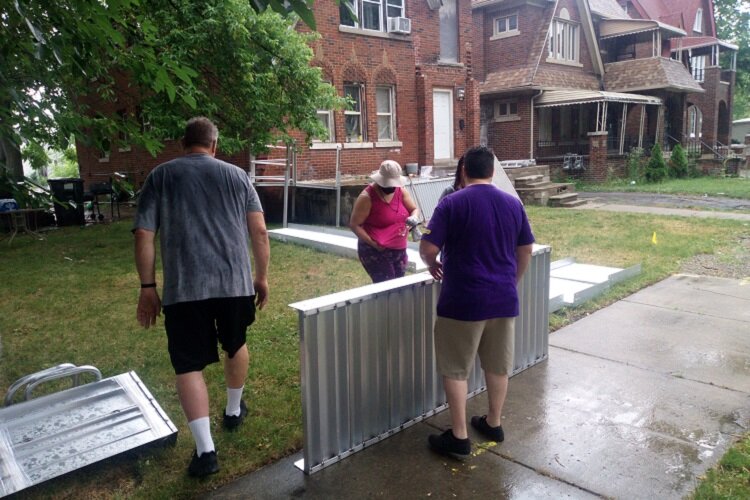 Volunteers install Dillard's new wheelchair ramp.