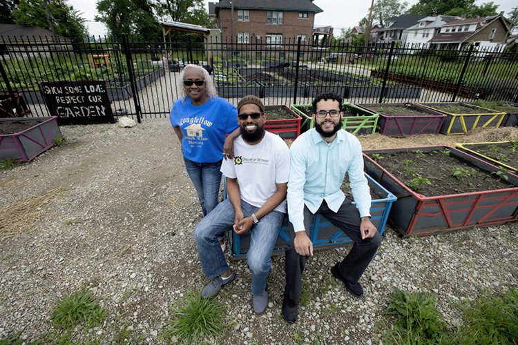 Mark Crain, Dream of Detroit project director, center, with volunteer Ali Sulemin, Dream of Detroit volunteer, and Teresa Clarrington, president of the Longfellow Block Club. 