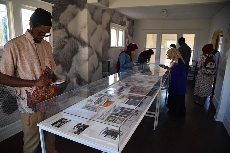 Choreographer Haleem "Stringz" Rasul peruses the Detroit exhibition of Halal Metropolis. 