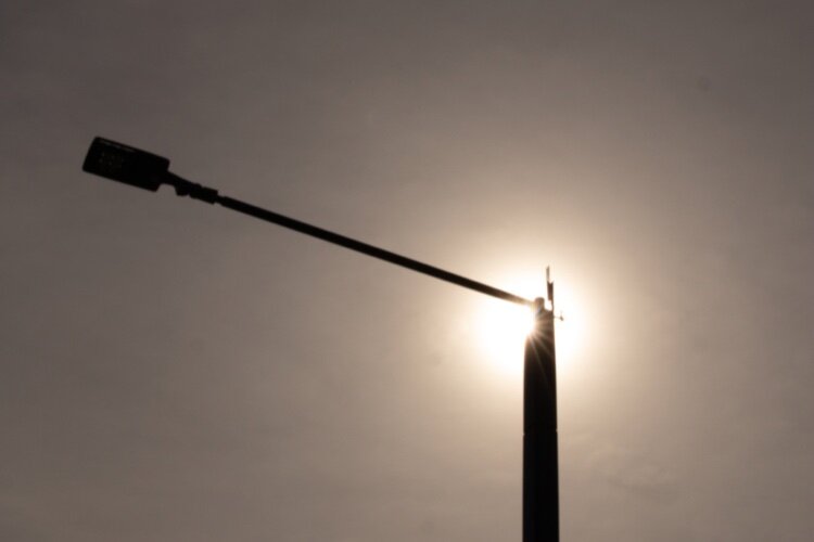 A solar-powered streetlight soaking up the sun in Highland Park.
