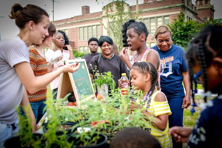 East Side Detroiters check out a farmers market booth.