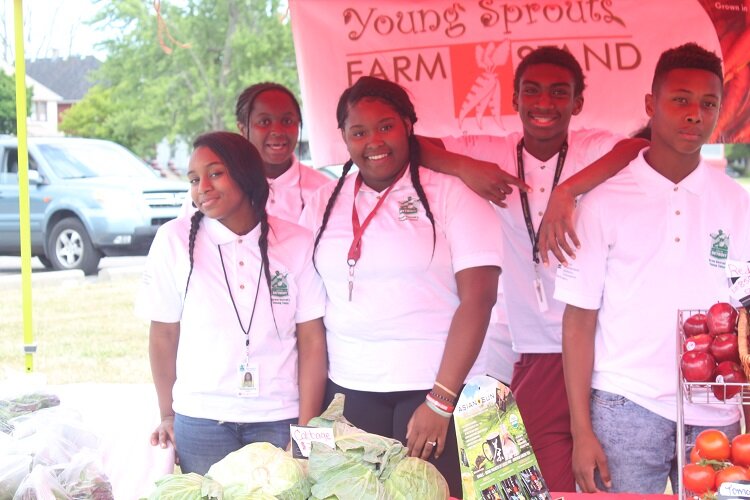 Youth from GenesisHOPE's Young Sprouts program work a farm stand.