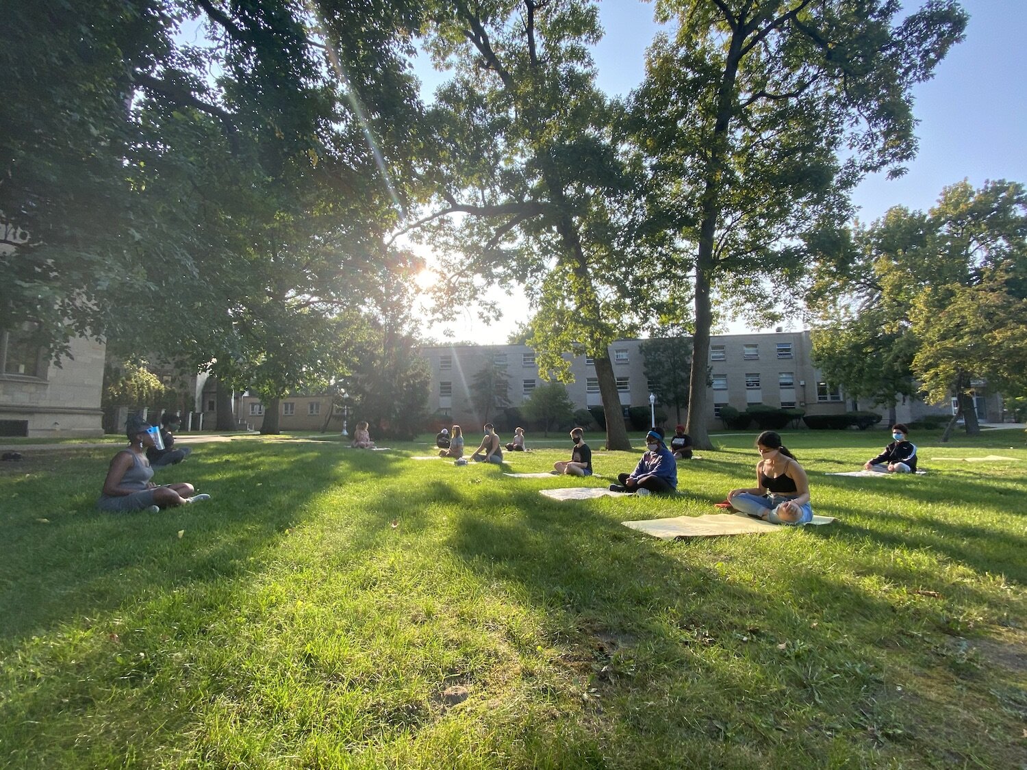 Yoga and breathing instructors Lauren Williams & Erin Allen with Day of Healing Participants outside Marygrove Conservancy Courtyard.