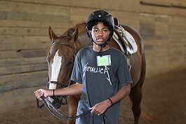 Detroit Horse Power program student Charles Johnson, 13, (8th grader) walks his horse around the training ring at Willowbrooke Farm in Plymouth.