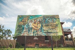 The mural titled “The Waiting” by Nicole Macdonald shows NW Goldberg residents boarding the 29 Linwood bus at the corner of Linwood and Ferry Park. 
