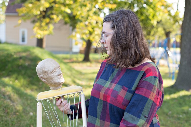 Carrie Morris poses with a Bunraku-style puppet she created at her performing arts non-profit in Detroit.