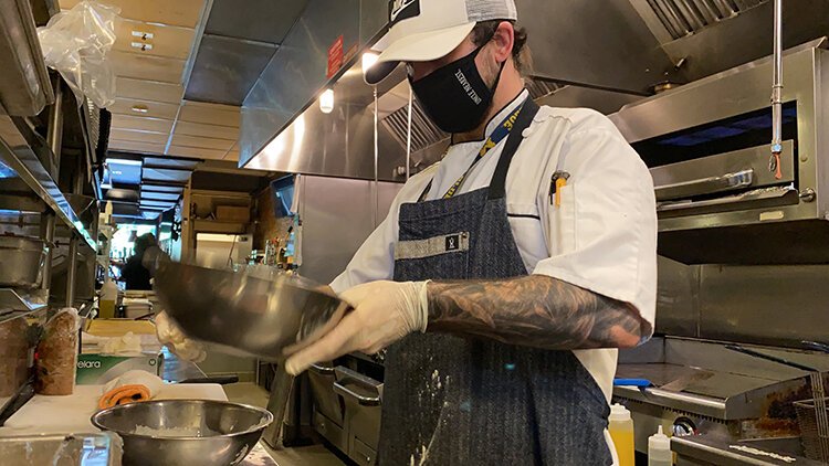 The Block's executive chef Adam Dorazio prepares the first online order: Woodward Wings.