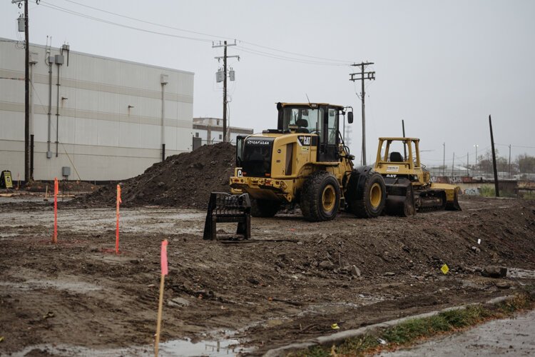 A bulldozer and other heavy vehicles help to build The Brooke on Bagley development.