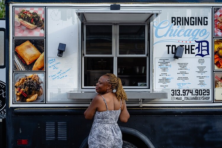 A customer makes an order at the Max Italian Beef food truck.