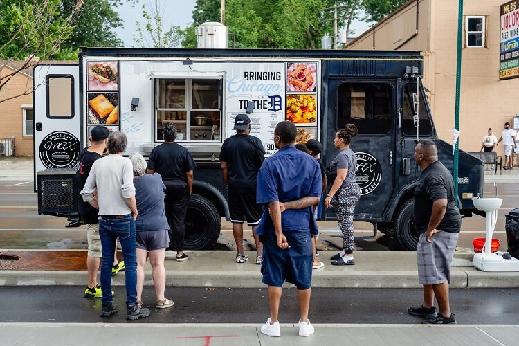 Several customers stand in line for the Max Italian Beef food truck.