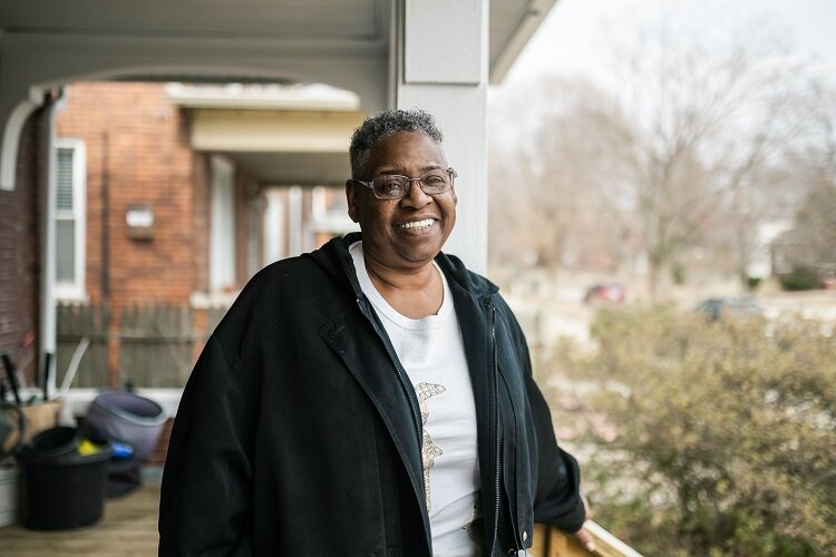 Islandview resident Daisy Jackson stands in front of her home.