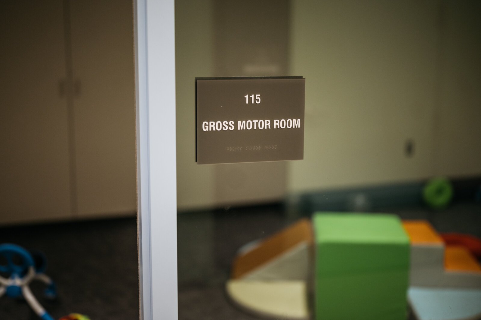 The center hosts indoor playrooms for infants, toddlers, and preschoolers. Gross motor activities include standing, jumping, running, throwing, and catching a ball.