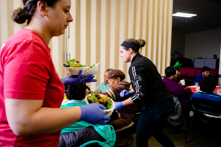 A Quicken volunteer helps out during the luncheon.