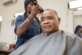 Barber David Freeman gives Andrew Burnett, Jr. a haircut at Transformations.
