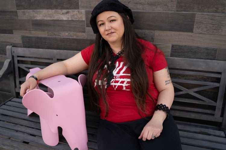 Ellen Lyle poses with a pink elephant.