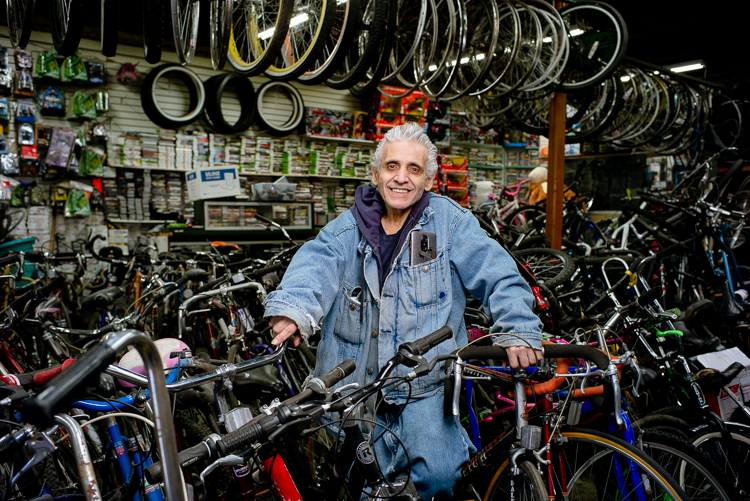 Sam Awada stands with a bicycle.